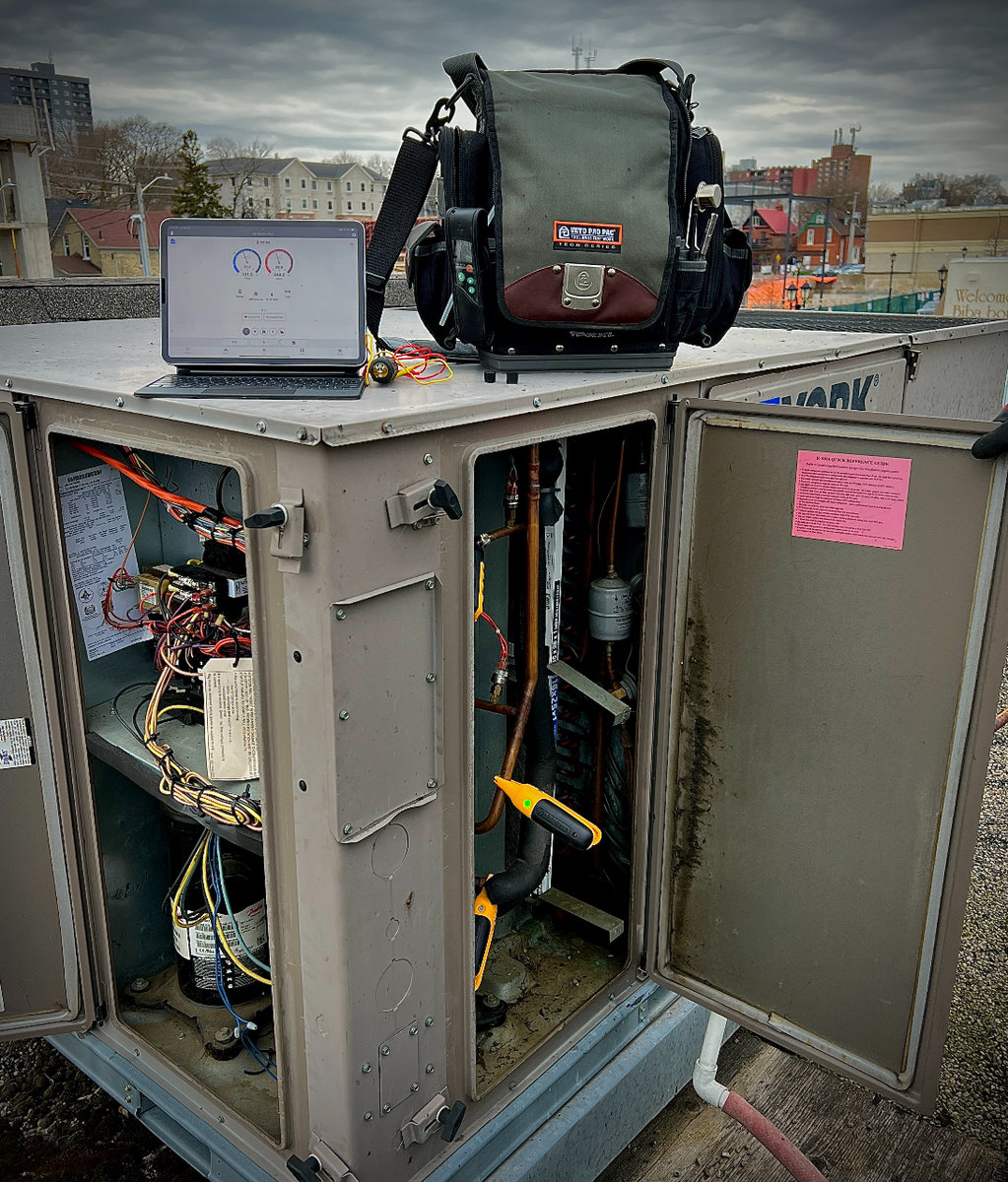 Advance Heating and Cooling providing expert rooftop commercial HVAC maintenance to optimize system efficiency